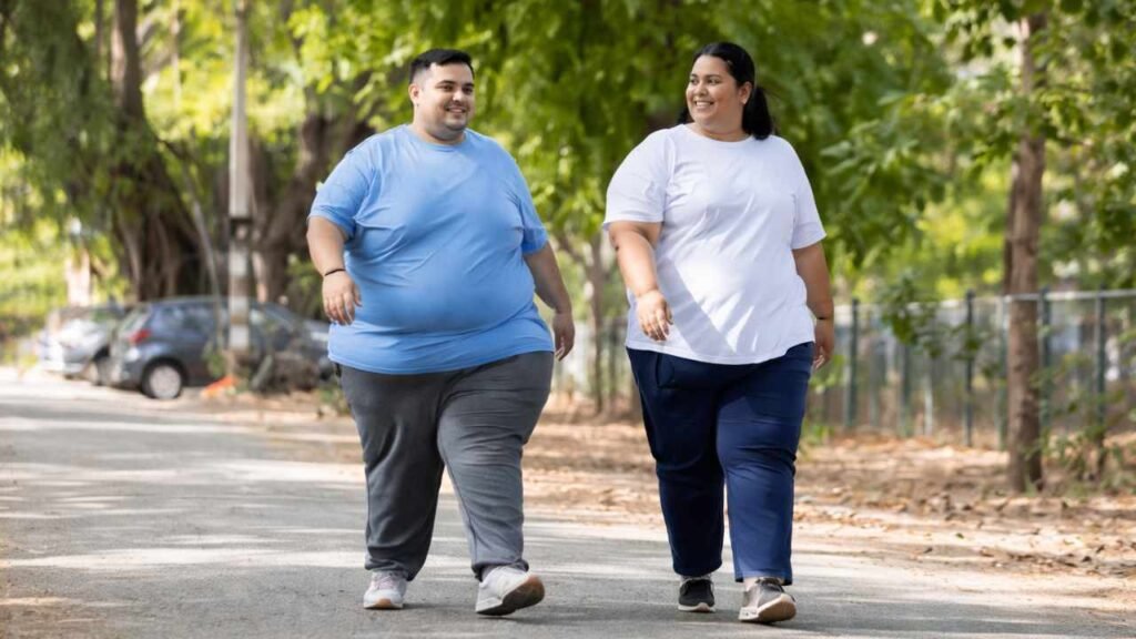 Overweight couple walking outdoors in a park for weight loss and healthy living through daily exercise habits.